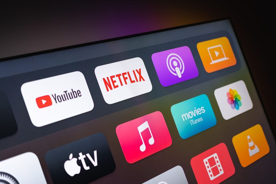 Several media and content streaming app icons are shown on a screen, including for YouTube and Netflix.